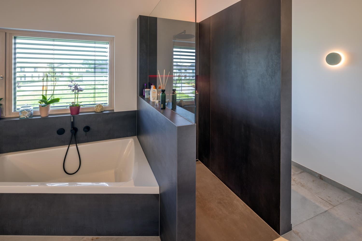 Holzhaus in Weilheim, hier Badezimmer mit unsymetrischer Badewanne und angrenzende Dusche